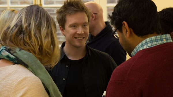 A photo of Olly with some students