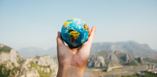 Photo of a hand holding a globe